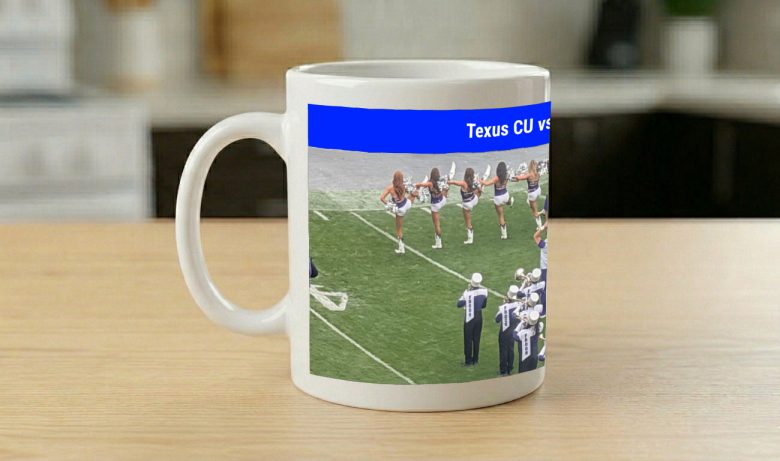 Mug printed with cheerleaders and a marching band under a blue banner naming the match